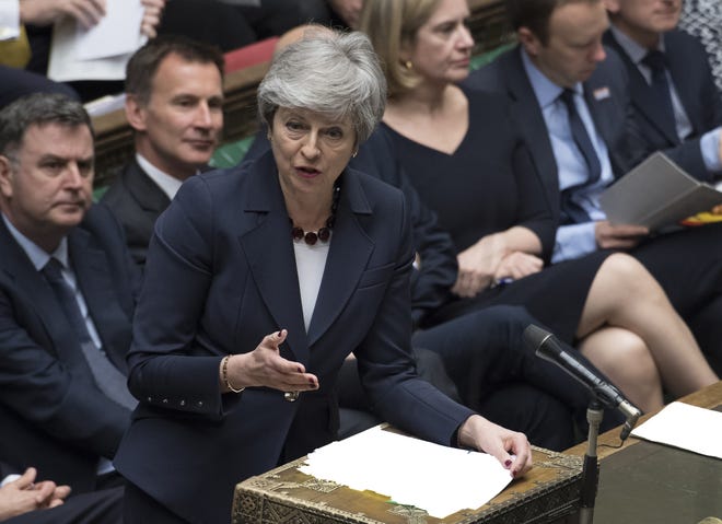 Britain's Prime Minister Theresa May stands to talk to lawmakers inside the House of Commons parliament in London Wednesday. As Lawmakers sought Wednesday for an alternative to May's unpopular Brexit deal with Europe, with a series of 'indicative votes", May offered to resign from office if her deal is passed by lawmakers at some point and Britain left the European Union. [Jessica Taylor/House of Commons]