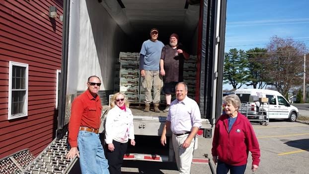 Wells Rotarians Dennis Hardy, Suzanne Islely, Rocky Furman, Doug Bibber and Terry Hodskins help the driver unload last year’s delivery of Vidalia Onions.

[Courtesy photo]