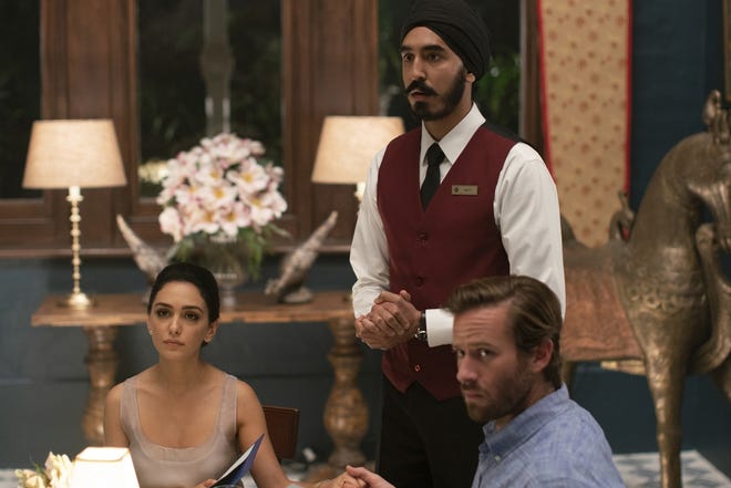 Nazanin Boniadi, left, stars as Zahra, an Indian heiress; Dev Patel as Arjun, a young Sikh waiter; and Armie Hammer as David, Zahra's American husband, in "Hotel Mumbai." [Bleecker Street]