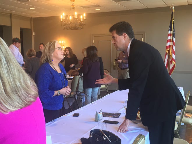 Alabama Secretary of State John Merrill, right, speaks with Rhonda Perry during a meeting of the Gadsden Rotary Club at the Gadsden Country Club on Thursday. Merrill spoke of the progress his office has made with the state's voting laws since he took office in 2015. [Dustin Fox/Gadsden Times]