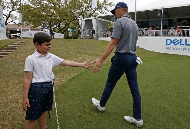 Julian Smith, 8, (left) greets Jordan Spieth on the first tee during the WGC-Dell Technologies Match Play held Friday at the Austin Country Club. Spieth was eliminated after group play was completed. [EDWARD A. ORNELAS/FOR STATESMAN]