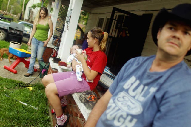 From left, family members Ronnie Duff, Love Faith Duff, Jacob Lucas and Hope Lucas gather on the porch in Owsley County on April 20, 2012 in Booneville, Ky. The 2010 U.S. Census listed Owsley County as having the lowest median household income in the country outside of Puerto Rico, with 41.5% of residents living below the poverty line. (Mario Tama / Getty Images / TNS)
