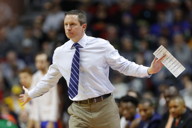 Florida coach Mike White directs his team during a first round game against Nevada in the NCAA Tournament on March 21 in Des Moines, Iowa. [AP Photo/Charlie Neibergall]