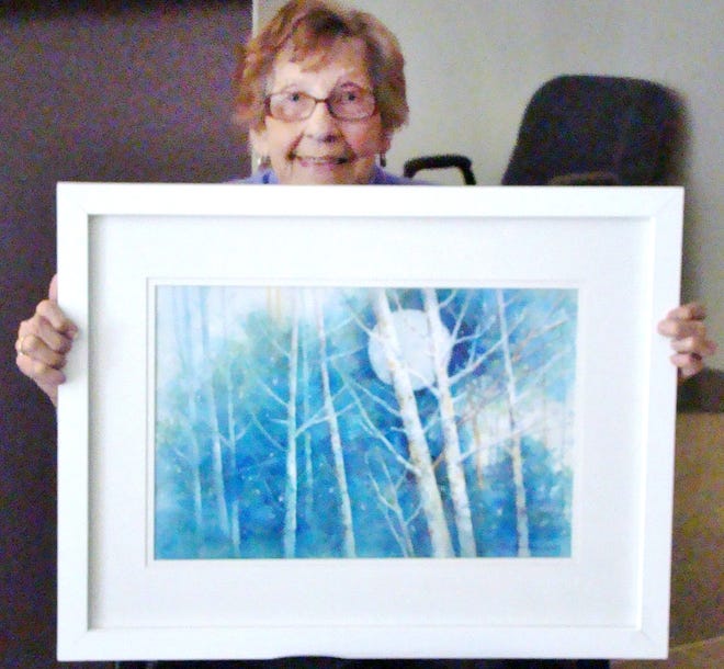 Virginia Price is pictured with the painting she donated for auction.