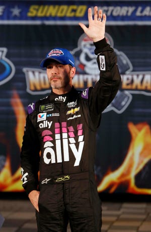 Jimmie Johnson (48) waves in victory lane after taking the pole position for the NASCAR Cup Series auto race at Texas Motor Speedway in Fort Worth, Texas, Friday, March 29, 2019. (AP Photo/LM Otero)