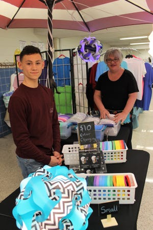 Aidan Bryant, of Prince George County, sells infinity lights at the Bunny Bazaar hoping to raise money for the Colonial Heights High School After Prom Celebration. Fellow vendor Kathy Wolfrom took time to check out his inventory, (Photos by Kristi K. Higgins/progress-index.com)