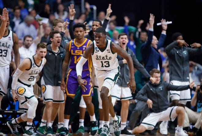 Michigan State forward Gabe Brown (13) and teammates react after he scored against LSU guard Marlon Taylor (14) during the second half Friday in an NCAA East Region semifinal in Washington. [Alex Brandon/The Associated Press]