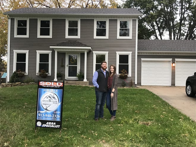 Newly married Topeka residents Keith and Emily Durall stand in front of their new home, recently purchased with the help of Keith's mother, Jana Hart Durall, a Realtor with Coldwell Banker Griffith & Blair, 2222 S.W. 29th St. [Submitted]