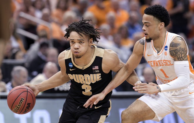 Purdue's Carsen Edwards (3) is defended by Tennessee's Lamonte Turner (1) during the second half of a men's NCAA Tournament college basketball South Regional semifinal game Thursday in Louisville, Ky. [TIMOTHY D. EASLEY/AP PHOTO]