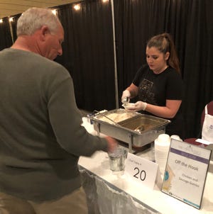 Rachel Faye of Off The Hook serves up a bowl of gumbo at the Home is Where the Heart Is gala fundraiser for The Haven at the Houma-Terrebonne Civic Center tonight. [Scott Yoshonis/Staff -- houmatoday/dailycomet]