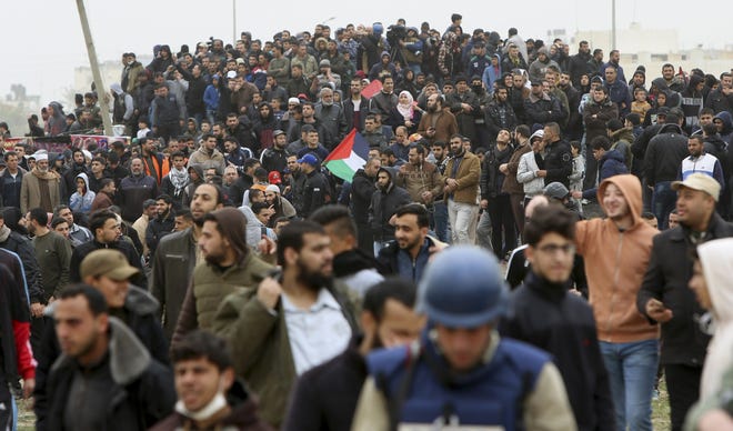 Protestors gather near the Gaza Strip's border with Israel, marking first anniversary of Gaza border protests east of Gaza City, Saturday, March 30, 2019. Tens of thousands of Palestinians gathered Saturday at rallying points near the Israeli border to mark the first anniversary of weekly protests in the Gaza Strip, as Israeli troops fired tear gas and opened fire at small crowds of activists who approached the border fence. (AP Photo/Adel Hana)