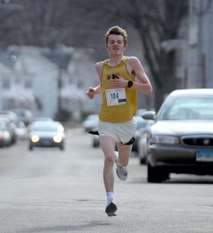 Brandon Mehlinger finishes first during the annual St. Joseph School’s 3 mile road race Saturday. [Aaron Flaum/NorwichBulletin.com]