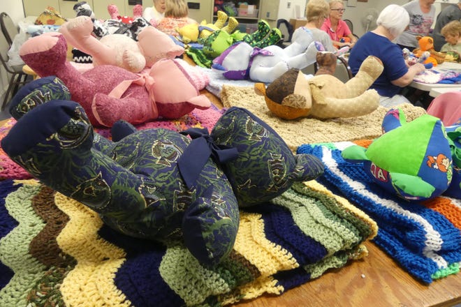 Colorful bears with coordinated afghans are lined up at the Royal Harbor Bear Club, which makes the sets for Camp Boggy Creek. [Linda Florea/Correspondent]