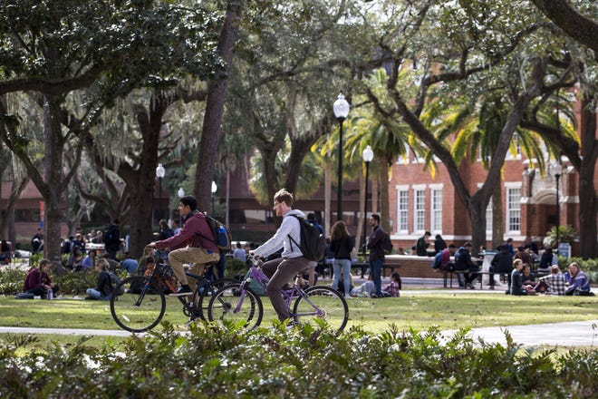 Students ride bikes to class across University of Florida's campus on Jan. 8, 2018. [gateHouse Media File]
