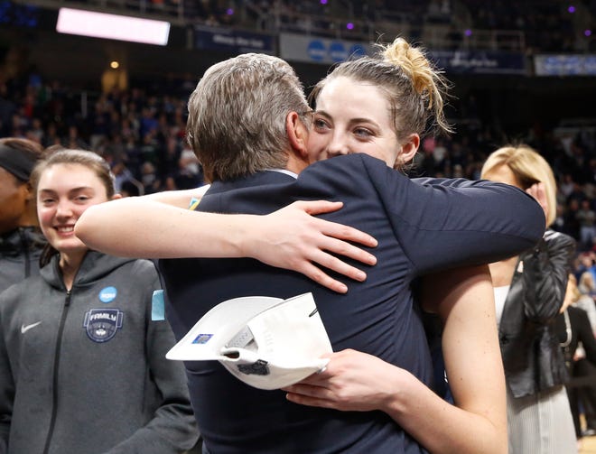 Connecticut head coach Geno Auriemma, front left, and top scorer Connecticut guard Katie Lou Samuelson embrace after defeating Louisville in a regional championship final in the NCAA women's college basketball tournament, Sunday, March 31, 2019, in Albany, N.Y. (AP Photo/Kathy Willens)