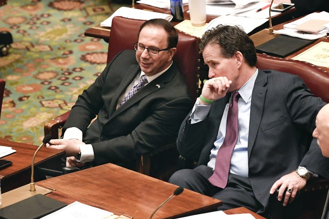 Senate Deputy Minority Leader Joseph Griffo, R-Utica, left, speaks with Senate Minority Leader John Flanagan, R-Smithtown, as Senate members debate budget bills in the Senate Chamber at the state Capitol Sunday, March, 31, 2019, in Albany, N.Y. (AP Photo/Hans Pennink)