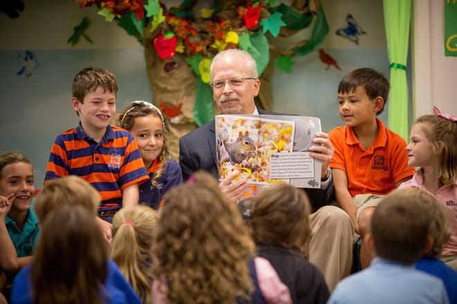 Bob Goldberg reads to students at The Benjamin School in an undated photo. [Photo provided by The Benjamin School]