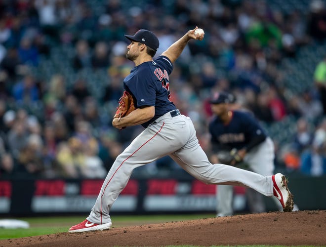 Boston Red Sox starting pitcher Nathan Eovaldi throws during the first inning of the team's baseball game against the Seattle Mariners, Friday, March 29, 2019, in Seattle. (AP Photo/Stephen Brashear)