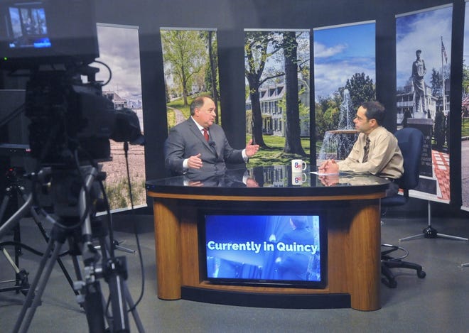 Quincy Access Television's "Currently in Quincy" host Joe Catalano, right, interviews Interim Quincy College President Michael Bellotti on Friday, Feb. 1, 2019. Communitry television advocates say a new rule issued by the Federal Communications Commissions threatens the future of local programming. (Tom Gorman/For The Patriot Ledger)