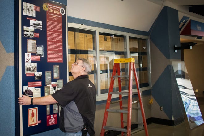 An exhibit commemorating Babe Ruth´s first home run in Fayetteville is taken down by David Bigsby at the Crown Coliseum so it can be displayed at the new Segra Stadium. [Photo by Jon Soles]