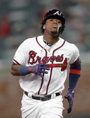 Atlanta Braves' Ronald Acuna Jr. rounds the bases after hitting a solo home run in the third inning of a baseball game against the Chicago Cubs, Monday, April 1, 2019, in Atlanta. (AP Photo/John Bazemore)