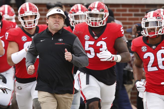 Georgia head coach Kirby Smart leads his team onto the field before a game. The Bulldogs will play home-and-home series with Florida State in 2027 and 2028 and Clemson in 2032 and 2033. The Bulldogs and Tigers are already set to play in the Chick-Fil-A Kickoff game in Atlanta’s Mercedes-Benz Stadium in 2024 and set up another home-and-home series in 2029 and 2030. [FILE/JOSHUA L. JONES/ATHENS BANNER-HERALD]