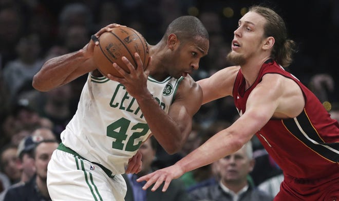 Celtics center Al Horford (left) prepares to drive against Heat and former Celtic forward Kelly Olynyk during the second half of Boston's 110-105 victory over Miami. Horford recorded his second career triple-double and first as a member of the Celtics in the win. [AP Photo/Charles Krupa]