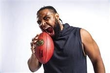 Clemson defensive lineman Christian Wilkins actually eats quarterbacks for breakfast, not footballs, but he could not resist posing during the NFL Scouting Combine. [TODD ROSENBERG/Associated Press]