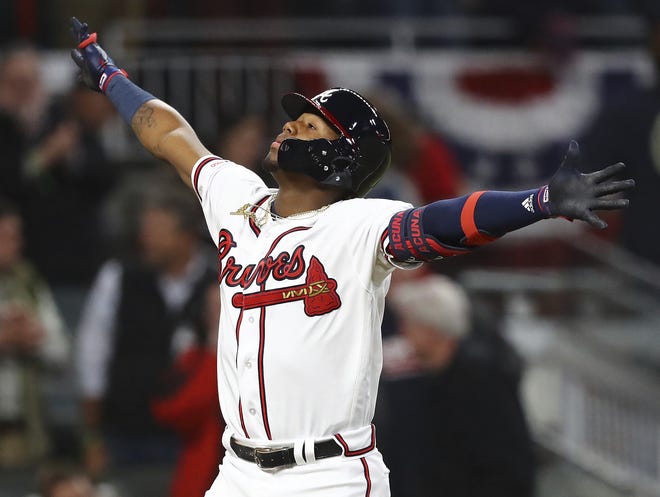 Atlanta Braves' Ronald Acuna Jr. reacts to hitting a solo home run for a 5-0 lead over the Chicago Cubs during the third inning of a baseball game, Monday, April 1, 2019, in Atlanta. (Curtis Compton/Atlanta Journal-Constitution via AP)