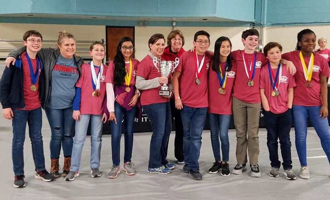 Pictured with their first place trophy, APA Varsity Science Olympiad team, left to right: Blake Brodish, Coach Candi Beaman, Samuel Hearon-Isler, Aneesha Jayaram, Coaches Karen Barker and Marie Swann, Max Begelman, Tien Le, Meade Evans, Christian Ouano, and Makky Mozie. [CONTRIBUTED PHOTO]