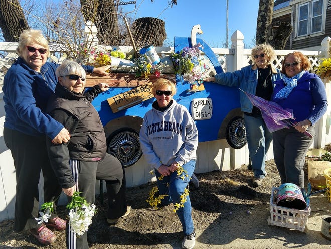 Members of the Sterling Garden Club (from left) Rosanne Mapp, Chris Corff, Barbara Reynolds, Beth Stephenson and Carol Stewart-Grinkiswere are busy switching out to spring decorations on a fence found on a stretch of Main Street in Sterling. [Item photo/DANIELLE RAY]
