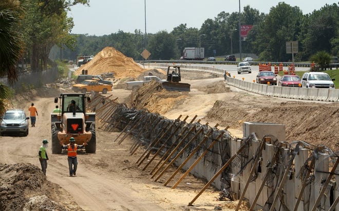 A construction crew works on an interstate off-ramp. [Gainesville Sun, File]