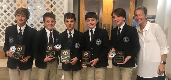 Rosarian Academy boys varsity soccer award winners -- from left, Jack Johnston, Win Ward, Brewer Rehm, James Molina, and Jack Beylo -- hold up their plaques with Coach Lindsey Beylo. [Courtesy Rosarian Academy]