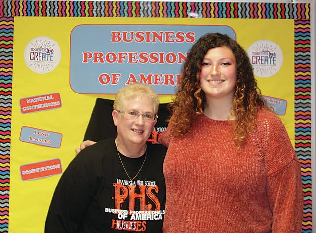Lynnlea McGuire, at right, a senior at Pawhuska High School, is shown here with her Business Professionals of America adviser Sharon Holloway. Holloway is helping McGuire prepare to deliver a speech at BPA nationals in California in early May. Robert Smith/Journal-Capital