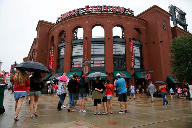 Fans toting rain gear head into Busch Stadium before the scheduled start a baseball game between the St. Louis Cardinals and the Milwaukee Brewers Saturday, July 2, 2016, in St. Louis. [File/AP]