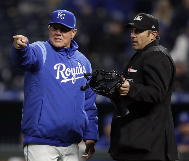 Kansas City Royals manager Ned Yost, left, questions home plate umpire Mark Ripperger during the 10th inning Tuesday night against the Minnesota Twins at Kauffman Stadium in Kansas City, Mo. The Twins defeated the Royals 5-4 in 10 innings. [Orlin Wagner/The Associated Press]