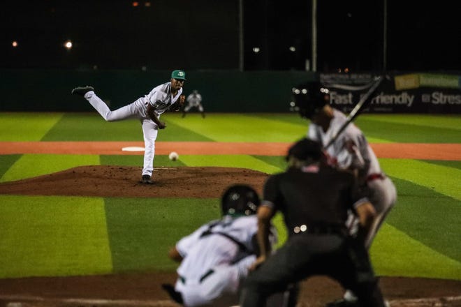 Cory Thompson (21) throws a pitch during a packed Tortugas opening night at Jackie Robinson Ballpark. [News-Journal / Lola Gomez]