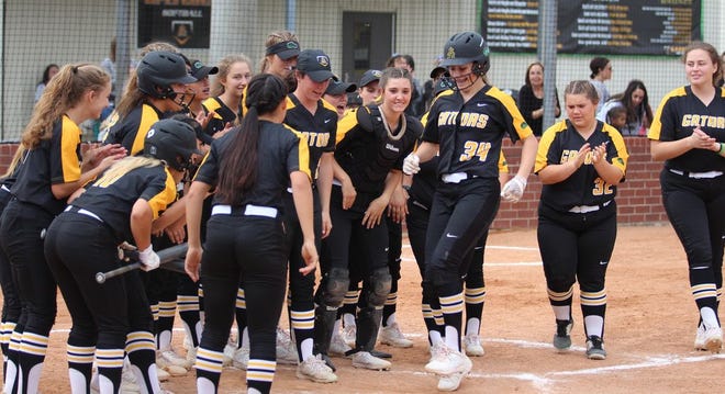 St. Amant's Julia Kramer (No. 34) reaches home plate after a solo home run. That homer ignited an 11-run inning for the Lady Gators. Photo by Kyle Riviere.