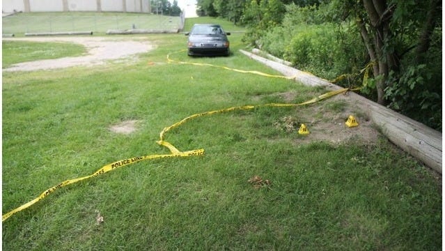 Crime tape surrounds Charles Oppenneer's car outside Gezon Park, where his body was found in July 2014. [Wyomig Department of Public Safety]
