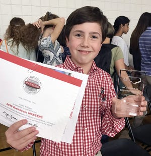 Austin Williams, a seventh grader at E.B. Frink Middle School, displays his winnings after taking a second place in the N.C. Science and Engineering Fair with a project about sound proofing.
