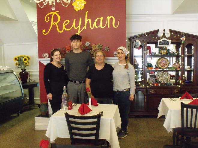 Reyhan Oner, second from right, opened Reyhan Sea & Mediterranean Grill on Gillespie Street in February. She previously owned Reyhan Turkish Kebaps on Person Street. Also shown are employees Bartu Selen, Tuba Collinsaadet and Shayna Thomas. [Alison Minard for The Fayetteville Observer]