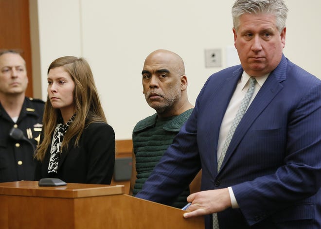 Former Columbus Police vice cop Andrew Mitchell appears for his arraignment between attorneys Kaitlyn Stevens and Mark Collins on charges stemming from the August shooting death of Donna Castleberry from inside the Franklin County courthouse on Friday. After being indicted by a grand jury the day before, Mitchell entered a plea of not guilty to the charges of murder and voluntary manslaughter. [Adam Cairns/Dispatch]