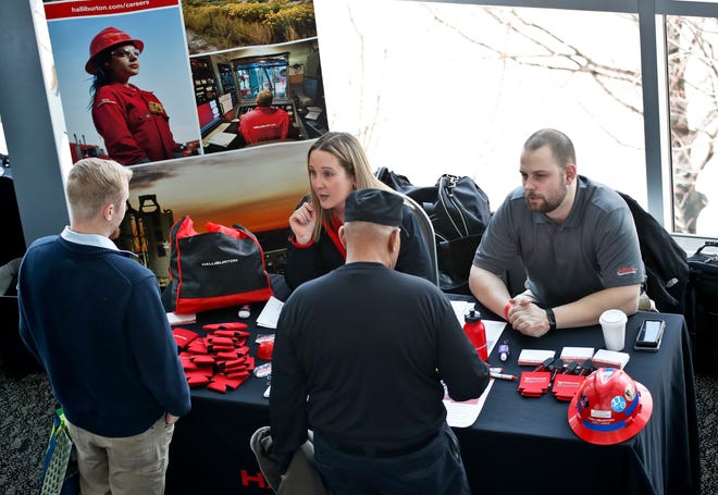 FILE- In this March 7, 2019, file photo visitors to the Pittsburgh veterans job fair meet with recruiters at Heinz Field in Pittsburgh. On Friday, April 5, the U.S. government issues the March jobs report. (AP Photo/Keith Srakocic, File)