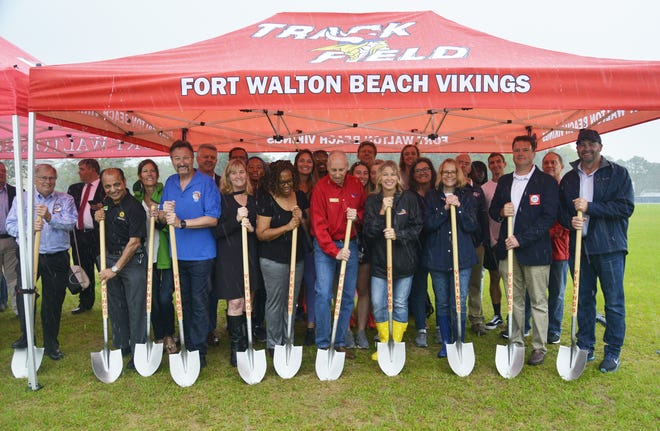 Fort Walton Beach High School held a groundbreaking ceremony for its new rubberized track on Friday. Pictured are key sponsors of the rubberized track initiative as well as members of the FWB track team and its coaches. [SAVANNAH VASQUEZ/DAILY NEWS]
