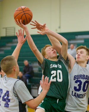 Florence Sawyer Middle School's Ashton Molzahn (center) is fouled while shooting by Luther Burbank's Liam Kelley (right) during the recent Middle School Play Day at Nashoba Regional High School. Also defending is Chase McClintock. [ITEM PHOTO/GRAHAM ENTWISTLE]