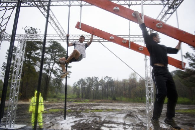 Rob Milligan, left, and Nick Manning on an obstacle course designed by Darren Jeffrey, who has designed courses for the "American Ninja Warrior" obstacle courses. [Melissa Sue Gerrits/The Fayetteville Observer]