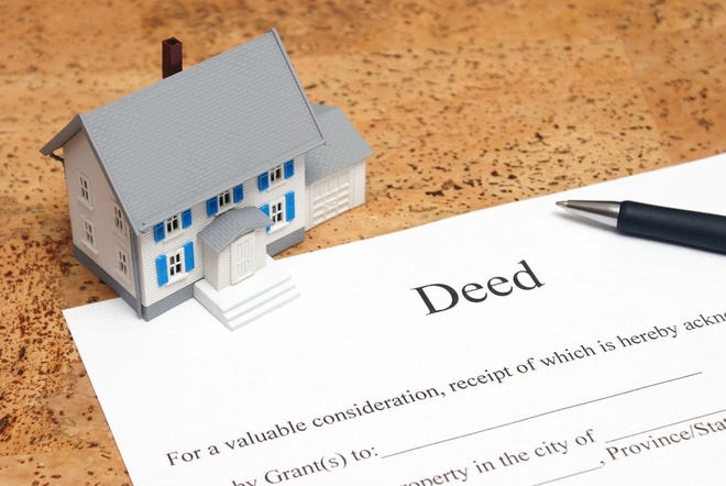 If a parent uses a quitclaim deed to sign over the title to their home to a child and that child records the document, the parent no longer owns the home. [Dreamstime.com]