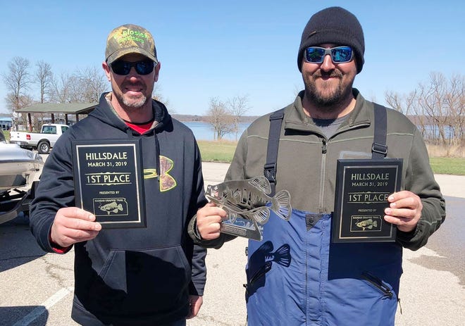 Gardner's Tony Niemeyer, left, and Louisburg's Ryan German hold up their first-place and Big Fish awards after winning the Kansas Crappie Trail season opener on Hillsdale Reservoir last weekend. [Submitted]