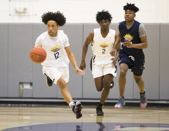 Tyus Brooks (12) and Keith Gilbert (2) run the break for the West All-Stars during Saturday's All-Star Classic at Gulf Coast. [JOSHUA BOUCHER/THE NEWS HERALD]