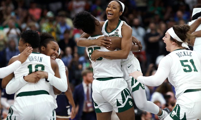 Baylor guard Chloe Jackson (24) hugs center Queen Egbo (25) after defeating Notre Dame in the Final Four championship game of the NCAA women's tournament Sunday in Tampa, Fla. BJackson's layup put Baylor ahead with 3.9 seconds left in the game. [CHRIS O'MEARA / THE ASSOCIATED PRESS]